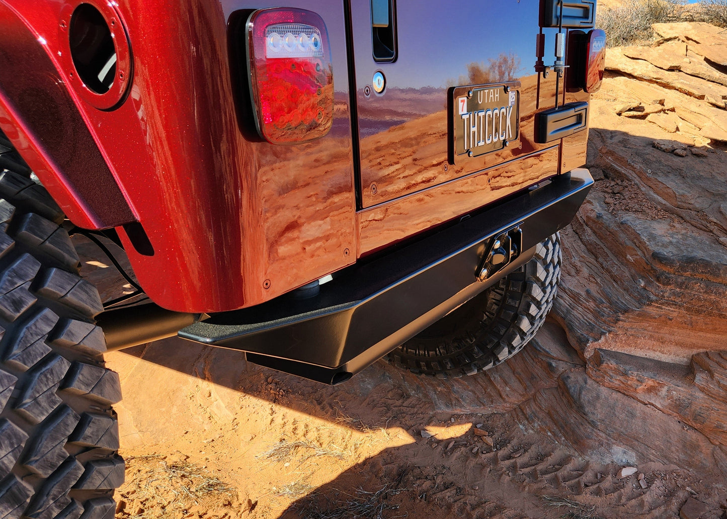 Red off-road vehicle on a rocky desert landscape