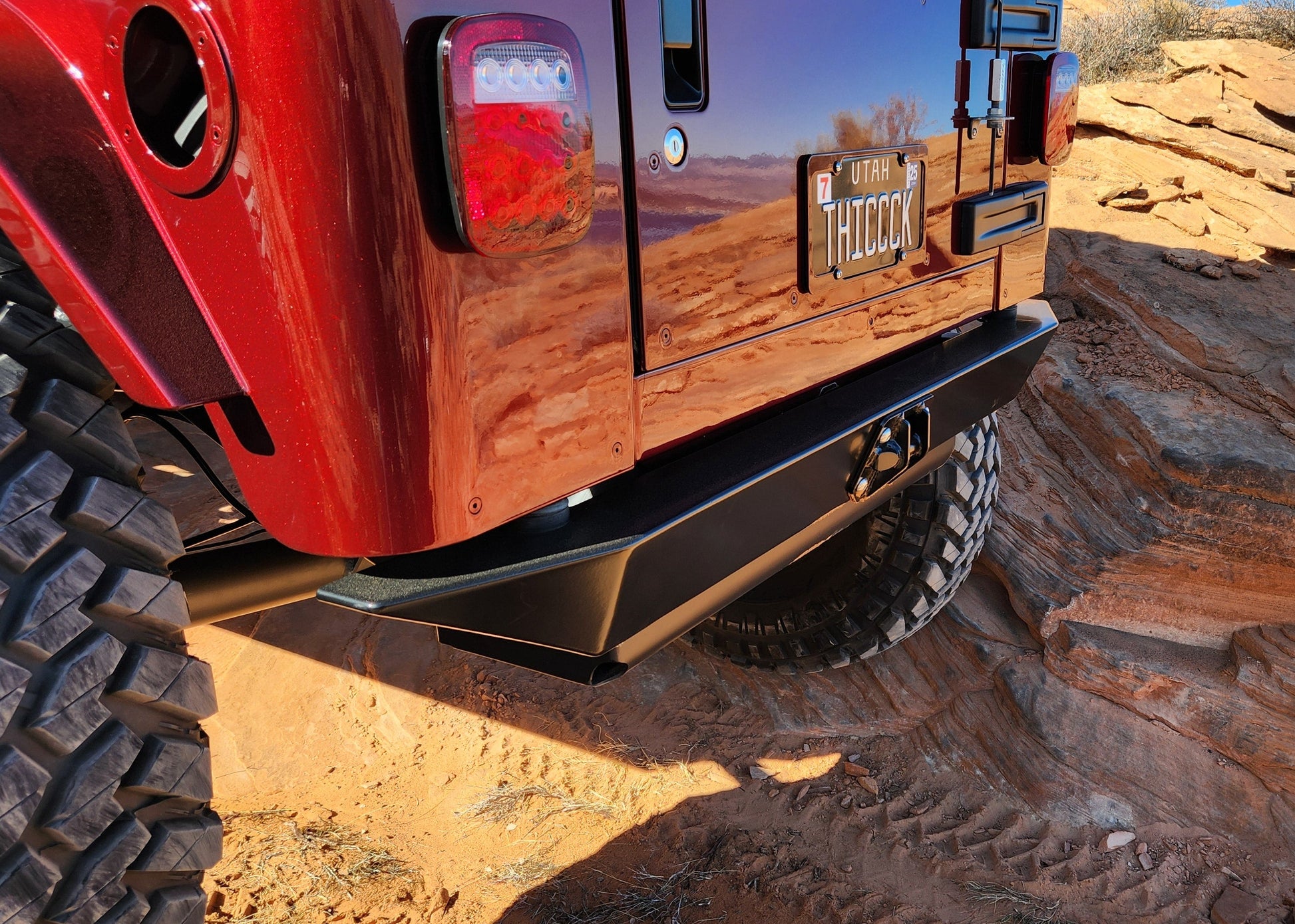 Red off-road vehicle on a rocky desert landscape